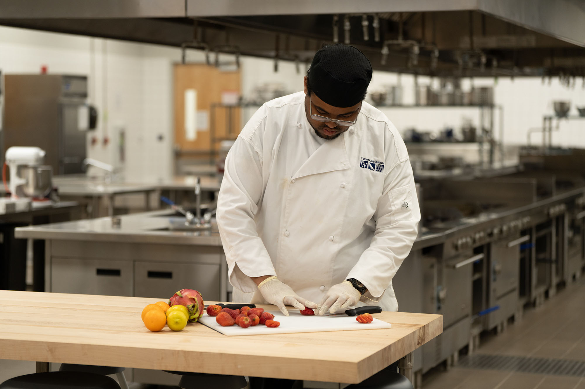 Culinary student chopping fruit